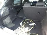 a trunk of a car with a bunch of wires in it