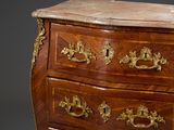 a wooden chest of drawers with a marble top