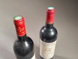 two bottles of wine sitting next to each other on a table