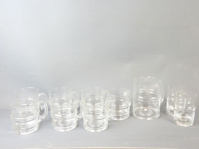 a lot of glasses that are lined up on the table
