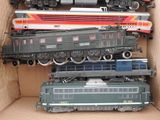 a lot of toy trains in a cardboard box