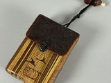 a small wooden box with a wooden bead on top of it