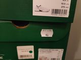 boxes of tennis shoes stacked on top of each other in a room