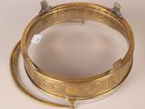 an image of a gold plate with a cross on top of it