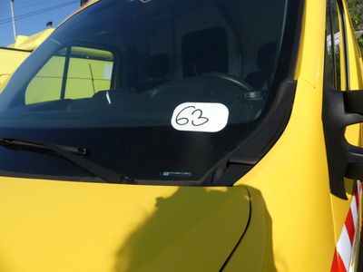 a yellow car with a sticker on the side of it