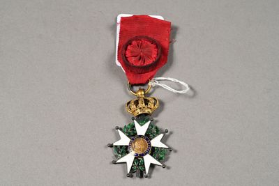 a red ribbon with a gold star and a crown on it