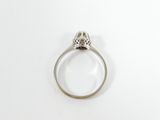 a close up of a diamond ring on a white surface