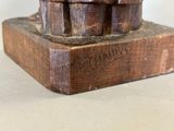 a wooden statue of a man on a skateboard