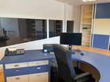 a desk with a computer monitor and a phone on it