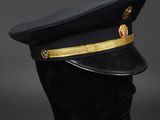 a black hat with gold trims on a mannequin head
