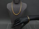 a mannequin with a gold chain on display