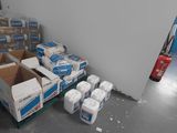 many boxes of toilet paper on the floor in the room