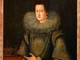 un tableau représentant une femme en robe verte tenant un livre