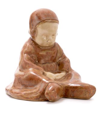 figurine of a woman sitting on her knees with a hat on