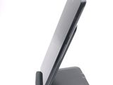 a cell phone on a stand on a white surface