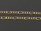 a close up of a gold chain on a black surface