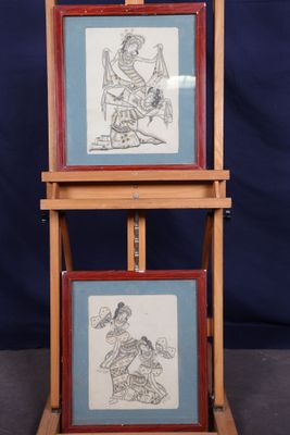 two framed pictures of a man and a woman on a stand