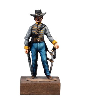 the figurine of a man with a gun is standing on a wooden base