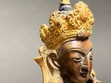 a gold statue of a woman with a crown on her head