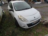 a small white car that is parked in the grass