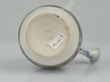 a close up of a vase with a tag on it