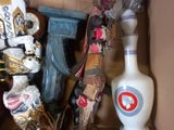 a cardboard box filled with assorted items and a vase