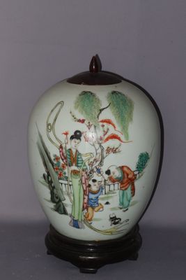 a white vase with a painting on it sitting on a table