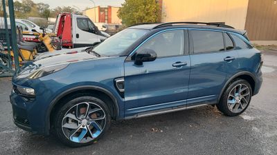 the blue suv is parked in a parking lot with other cars