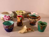 many different colored vases and bowls on the table