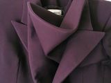 a close up of a purple jacket on a hanger