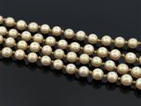 un gros plan d'un collier de perles sur une surface noire
