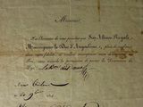 an old document with writing on it sitting on top of a table