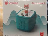 someone is holding up a box with a toy cat in it