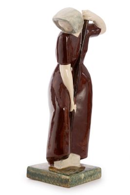 figurine of a woman with a hat and a cane on a marble base