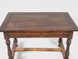 an old wooden table with turned legs and a wooden top