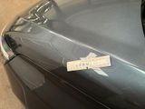 a sticker on the hood of a car that is parked