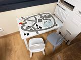 a small table with a map on it next to a chair