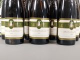 six bottles of wine are lined up on a table