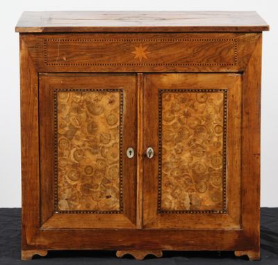 an old wooden cabinet with two doors and a drawer on top