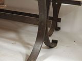 a table that has a glass top and metal legs
