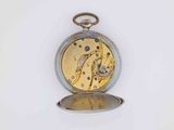 a silver pocket watch with a gold dial on a white background