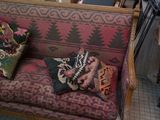 a couch that has some pillows on it in a room