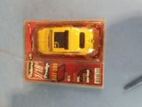 a yellow toy car sitting on top of a box