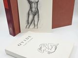 the book is open to show a drawing of a nude