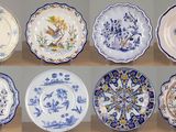 several plates with blue and white designs on them on a table
