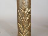 a gold vase sitting on a table with a white background