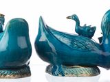 two blue birds that are sitting on top of each other