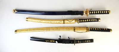 four different types of swords are lined up on a white surface
