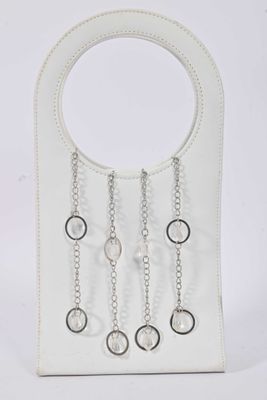 white leather purse with silver chains hanging from it ' s handle
