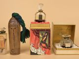 a bottle of perfume and a box of perfumes on a table